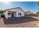 Backyard features a covered patio area and low-maintenance gravel at 513 S 115Th Dr, Avondale, AZ 85323