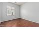 Spacious bedroom with neutral walls, hardwood floors, and a window with blinds at 513 S 115Th Dr, Avondale, AZ 85323