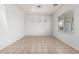 The bedroom features neutral tile flooring, white walls, and large windows with blinds for ample natural light at 513 S 115Th Dr, Avondale, AZ 85323