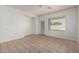 Bright living room with tile floors and abundant natural light from windows and patio door at 513 S 115Th Dr, Avondale, AZ 85323
