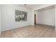 Bright living room featuring neutral tile flooring, white walls, and a large window allowing ample natural light at 513 S 115Th Dr, Avondale, AZ 85323