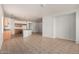 Open-concept living room with tile floors adjacent to the kitchen, offering ample space for entertaining at 513 S 115Th Dr, Avondale, AZ 85323