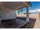 Covered patio overlooks a backyard featuring a gravel covering and tall beige fence at 513 S 115Th Dr, Avondale, AZ 85323