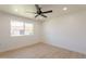 This bedroom features light wood floors, a ceiling fan, and a bright window at 5132 N 83Rd St, Scottsdale, AZ 85250