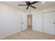 This bedroom features light wood floors, a ceiling fan, and closet access at 5132 N 83Rd St, Scottsdale, AZ 85250