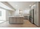 Beautiful kitchen features stainless appliances, gray island, and sliding glass door providing natural light at 5132 N 83Rd St, Scottsdale, AZ 85250