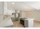 Kitchen with white and gray cabinets, stainless steel appliances, white countertop island, and designer finishes at 5132 N 83Rd St, Scottsdale, AZ 85250