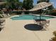 Inviting community pool with shade umbrellas, a table and chairs set at 5132 N 83Rd St, Scottsdale, AZ 85250