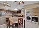 Modern kitchen with laundry appliances and adjacent dining area at 5144 W Sweetwater Ave, Glendale, AZ 85304