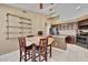 Spacious kitchen with dark cabinetry, granite countertop, and dining area at 5144 W Sweetwater Ave, Glendale, AZ 85304
