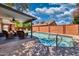 Backyard swimming pool with covered patio and seating area at 5144 W Sweetwater Ave, Glendale, AZ 85304