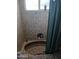 Enclosed bathroom bathtub, surrounded by beige tile at 5539 N 31St Ln, Phoenix, AZ 85017