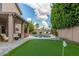 Backyard oasis featuring a pool, tanning deck, covered patio, and a putting green at 6449 E Paradise Ln, Scottsdale, AZ 85254