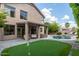 Expansive backyard with pool, lush landscaping, patio, and putting green for outdoor enjoyment at 6449 E Paradise Ln, Scottsdale, AZ 85254