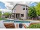Inviting backyard with a sparkling pool, lounge chairs, covered patio, and well-manicured lawn and landscaping at 6449 E Paradise Ln, Scottsdale, AZ 85254