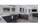 Modern kitchen features stainless appliances, stone countertops, and seamless flow into the living area at 6449 E Paradise Ln, Scottsdale, AZ 85254