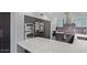 Modern kitchen featuring gray cabinetry, stainless appliances, and island counter seating at 6449 E Paradise Ln, Scottsdale, AZ 85254