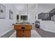 Open-concept living area with foosball table, staircase, and modern lighting at 6449 E Paradise Ln, Scottsdale, AZ 85254