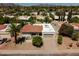 Aerial shot of the property showcases a tile roof, lush landscaping, and mountain views at 7618 N Via Del Paraiso --, Scottsdale, AZ 85258