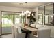 Elegant dining room with natural light, stylish chandelier, and ample seating for hosting gatherings at 7618 N Via Del Paraiso --, Scottsdale, AZ 85258