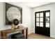 Welcoming entryway features a wood console table, stylish decor, and a glass-paneled front door at 7618 N Via Del Paraiso --, Scottsdale, AZ 85258