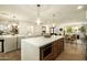 Open-concept kitchen with a large island, modern lighting, and seamless flow into the dining and living areas at 7618 N Via Del Paraiso --, Scottsdale, AZ 85258