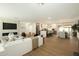 Open-concept living room featuring a fireplace, modern kitchen, dining area, and light wood flooring at 7618 N Via Del Paraiso --, Scottsdale, AZ 85258