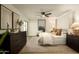 A bright main bedroom with decor, light wood floors, a ceiling fan, and a sitting area at 7618 N Via Del Paraiso --, Scottsdale, AZ 85258