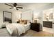 Main bedroom featuring a ceiling fan, warm lighting, and an en-suite bathroom at 7618 N Via Del Paraiso --, Scottsdale, AZ 85258