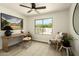 Bright home office with wood desk, chair, and a large window view of the outdoor space at 7618 N Via Del Paraiso --, Scottsdale, AZ 85258