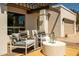 Cozy patio area with stylish outdoor seating, a coffee table, and an attached garage at 7618 N Via Del Paraiso --, Scottsdale, AZ 85258