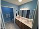 Bright bathroom with double sink vanity, tile floors, and illuminated mirror at 8255 E Kiva Ave # 430, Mesa, AZ 85209