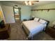 Bedroom showcasing soft natural light, carpet, and ensuite bathroom entrance at 8255 E Kiva Ave # 430, Mesa, AZ 85209