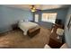 Cozy bedroom featuring a ceiling fan, natural light, and carpeted floors at 8255 E Kiva Ave # 430, Mesa, AZ 85209