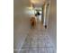 Inviting hallway with neutral tile flooring, a wooden console table, and access to multiple rooms at 8255 E Kiva Ave # 430, Mesa, AZ 85209