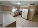 Functional kitchen equipped with classic cabinets, white appliances, and ample counter space with tile floors at 8255 E Kiva Ave # 430, Mesa, AZ 85209
