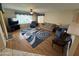 Well-lit living room showcasing hardwood floors, a ceiling fan, and comfortable seating arrangements at 8255 E Kiva Ave # 430, Mesa, AZ 85209