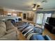 Spacious living room featuring hardwood floors, a ceiling fan, and an open concept design to kitchen and dining area at 8255 E Kiva Ave # 430, Mesa, AZ 85209