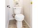 Cozy bathroom featuring a white toilet with decorative plant and modern fixtures at 8343 W Audrey Ln, Peoria, AZ 85382