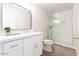 Modern bathroom featuring a vanity, large mirror, and a glass-enclosed shower with marble-style tile at 8343 W Audrey Ln, Peoria, AZ 85382