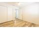 Bedroom with neutral walls, laminate wood flooring, ceiling fan, and closet at 8343 W Audrey Ln, Peoria, AZ 85382