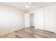 Bedroom with neutral walls, laminate wood flooring, ceiling fan, and closet at 8343 W Audrey Ln, Peoria, AZ 85382