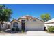 Charming single-story home with desert landscaping, arched entry, and attached two-car garage at 8343 W Audrey Ln, Peoria, AZ 85382