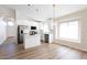 Modern kitchen with stainless steel appliances, white cabinetry, an island and a view to the dining area at 8343 W Audrey Ln, Peoria, AZ 85382