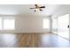 Bright and airy living room with wood-look flooring, neutral walls, and large windows offering lots of natural light at 8343 W Audrey Ln, Peoria, AZ 85382