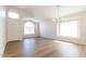 Inviting living room with vaulted ceilings, natural light, and wood-look flooring, creating a welcoming atmosphere at 8343 W Audrey Ln, Peoria, AZ 85382