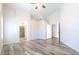 Spacious primary bedroom featuring wood flooring and a peek into the ensuite bathroom at 8343 W Audrey Ln, Peoria, AZ 85382