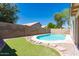 Private backyard pool oasis with lush green landscaping and privacy fence at 8343 W Audrey Ln, Peoria, AZ 85382