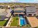 An inviting pool, patio, and green lawn are highlighted in the backyard aerial view at 8754 W San Juan Ave, Glendale, AZ 85305