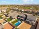 A beautiful home features a sparkling pool, lush lawn, and desert mountain views at 8754 W San Juan Ave, Glendale, AZ 85305